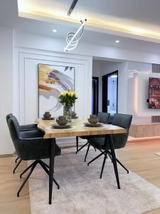 a dining room with a wooden table and chairs at Royal Living Pure definition of luxury in Nairobi +9 photos