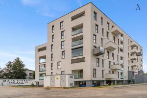 an apartment building with a gray at Maia Apartment with One Bedroom & Fully kitchen in Bucharest