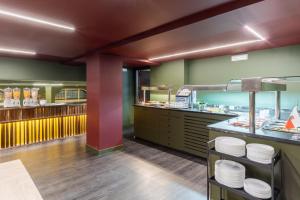 a restaurant with green walls and white plates on a counter at Abba Santander in Santander +19 photos