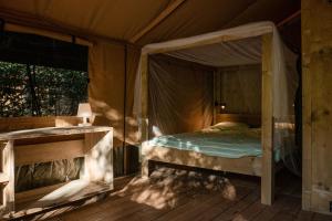 a bedroom with a bed in a tent at Lodge Holidays - Camping Delle Rose in Case Romagnoni