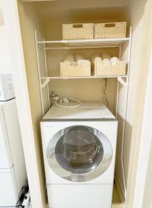 東京にあるF-Mansion209の小さな部屋に洗濯機と乾燥機があります。