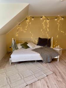 una camera da letto con un letto con luci sul muro di A Studio That Warms the Soul a Tapa Altre 2 foto
