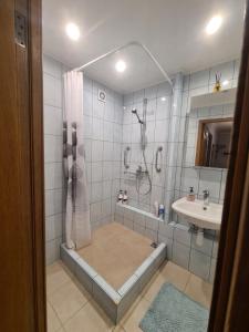 a bathroom with a shower and a sink at Istabiņa Carnikavā in Carnikava
