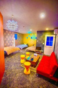 a large room with two beds and a red couch at Villa Inuyama - Vacation STAY 87603v in Inuyama