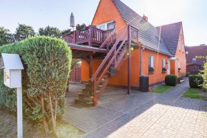 a house with a staircase on the side of it at Sonnenblumenhaus 01 in Prerow