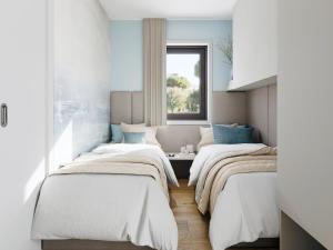 a room with three beds and a window at Amadria Exclusive Beach Villa in Šibenik +42 photos