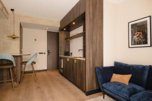 a living room with a couch and a table at Hotel Philippe Suites I Kloeg Collection in Philippine