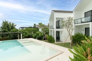 an image of a swimming pool in front of a house at Villa Valeria in Ungasan