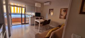 a living room with a table and a couch at Apartamentos Neptuno in Platja  d'Aro