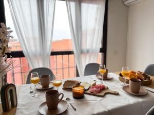 a table with a plate of food and glasses of wine at Fuensalida Homes 204 in Fuensalida +19 photos