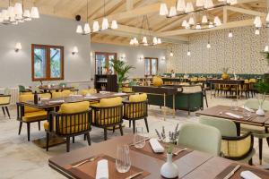 a dining room with wooden tables and chairs at Amadria Exclusive Beach Villa in Šibenik