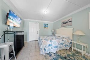 a bedroom with a bed and a flat screen tv at Beachview 312 in Gulf Shores