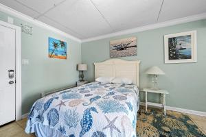 a bedroom with a bed with a blue wall at Beachview 312 in Gulf Shores