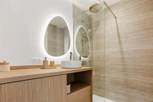 a bathroom with a sink and two mirrors at La Suite Régina - Downtown, terrace, parking in Sainte-Maxime +8 photos