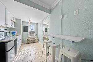 a kitchen with two stools and a counter top at Beachview 312 in Gulf Shores