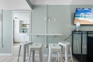 a group of stools in a room with a tv at Beachview 312 in Gulf Shores +14 photos