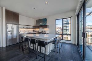 a kitchen with a large white table and chairs at 121 Hotel Floor 3 Buyout by AvantStay Entire Third Floor Buyout of 121 Hotel Sleeps 18 in Nashville