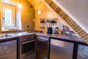 a kitchen with stainless steel appliances and a staircase at Luxury House FV in Formello