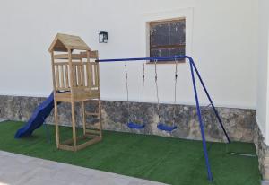 a playground with a swing and a ladder at Casa Gregal CR Los Cuatro Vientos in Moratalla