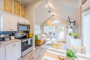 a kitchen and living room with a table and chairs at Rainforest Tiny Home Retreat Nordic in Forks