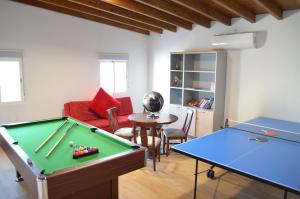 a living room with a pool table and two ping pong tables at Villa Mónica by Mirador de Sotavento Apartments in Cardón