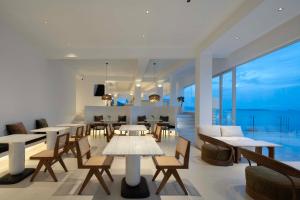 a restaurant with tables and chairs and a view of the ocean at Shenzhen GuanHu Secret Wild Reef Seaview Hotel in Shenzhen