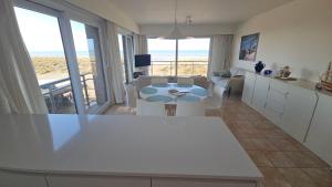 a kitchen and living room with a view of the ocean at Zeemeermin in Nieuwpoort