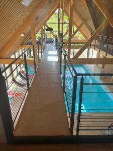 a view of a swimming pool in a building at La Fontaine - Détente - Piscine Jacuzzi - 12p in La Chartre-sur-le-Loir
