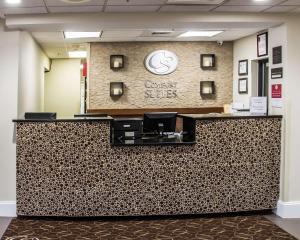 a lobby of a dental office with a reception counter at Comfort Suites University - Research Park in Charlotte +19 photos
