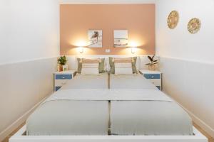 a bedroom with a bed and two night stands at Casa Bettì - Canaima, Puerto Rico in Puerto Rico de Gran Canaria