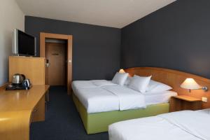 Postel nebo postele na pokoji v ubytování OREA Hotel Voro Brno + 33 fotografií