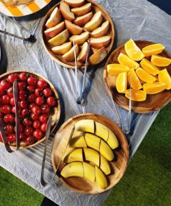 four bowls of apples and fruit on a table at Stay Pohang Hotel in Pohang +12 photos