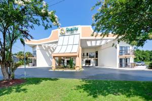 a large white building with a sign on it at Quality Inn Selma - Smithfield in Selma