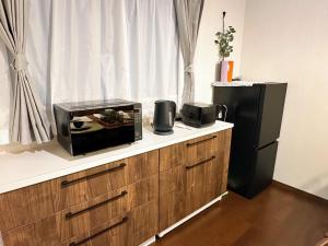 Dapur atau dapur kecil di 全新包棟民宿 近玉出車站 玉寓 拾光