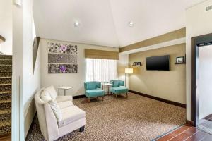 a living room with a couch and two chairs and a tv at Sleep Inn Hickory South in Hickory