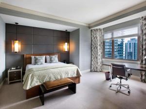 a bedroom with a large bed and a desk at Fairmont Chicago Millennium Park in Chicago