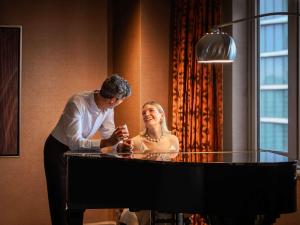 a man standing next to a woman at a table at Fairmont Chicago Millennium Park in Chicago