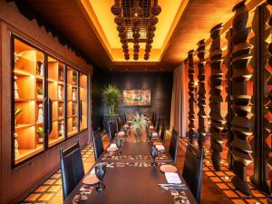 a long dining room with a long table and chairs at Fairmont Chicago Millennium Park in Chicago