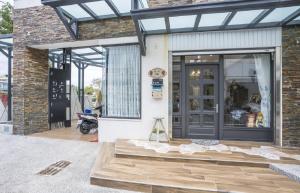 a store front with a glass door and a porch at 綠道74民宿Green Lane 74 in Hualien City