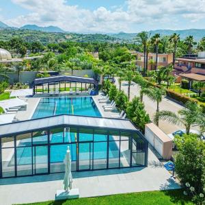 an aerial view of a building with a swimming pool at Corniola wellness & spa in Furnari