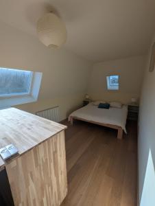 a bedroom with a bed in a small room at WimSaens in Wimereux