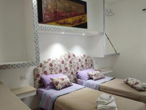 a room with two beds and a chair at agriturismo heaven in Capo Vaticano