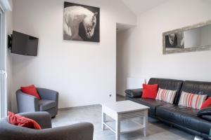 a living room with a couch and a table at La Diligence - Jardin parking privé in Damery