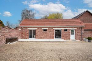a brick house with a red roof at La Diligence - Jardin parking privé in Damery +4 photos