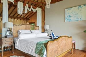 a bedroom with a large bed and a wooden ceiling at Hillside Chalet with panoramic views in Amed +27 photos