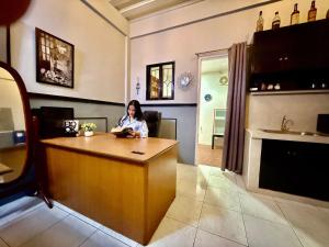a woman sitting at a counter in a restaurant at Axon Cozy Modern House G Near The Walking Street in Angeles