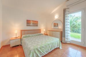 En eller flere senge i et værelse på Villetta Biodola Beach