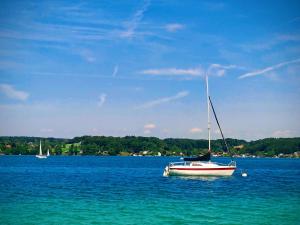 a boat sitting in the middle of a large body of water at Apartment-DGW in Rutzenmoos