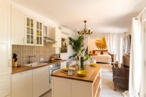 a kitchen with white cabinets and a counter top at Sol Amarillo in Mijas Costa