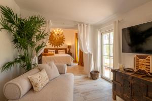 a living room with a couch and a bedroom at Sol Amarillo in Mijas Costa